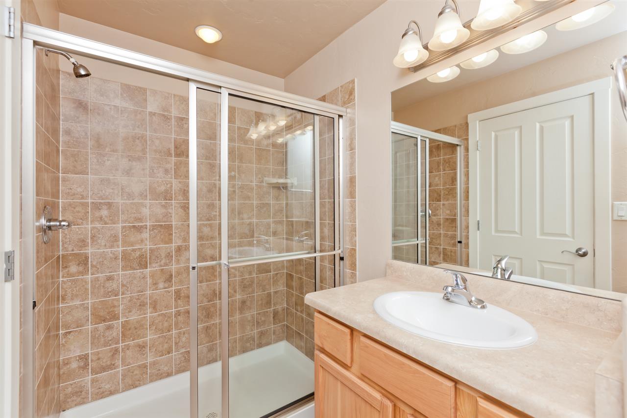 3138 Dublin Way Grand Junction, CO 81504 - Photo 22 of 42 a bathroom with a sink a large mirror and a shower