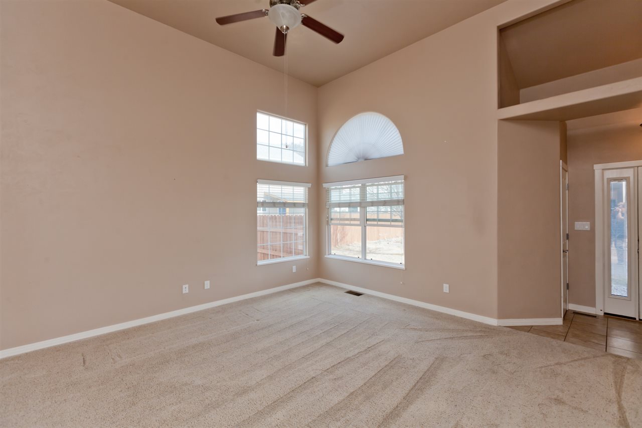 3138 Dublin Way Grand Junction, CO 81504 - Photo 3 of 42 an empty room with chandelier fan and windows
