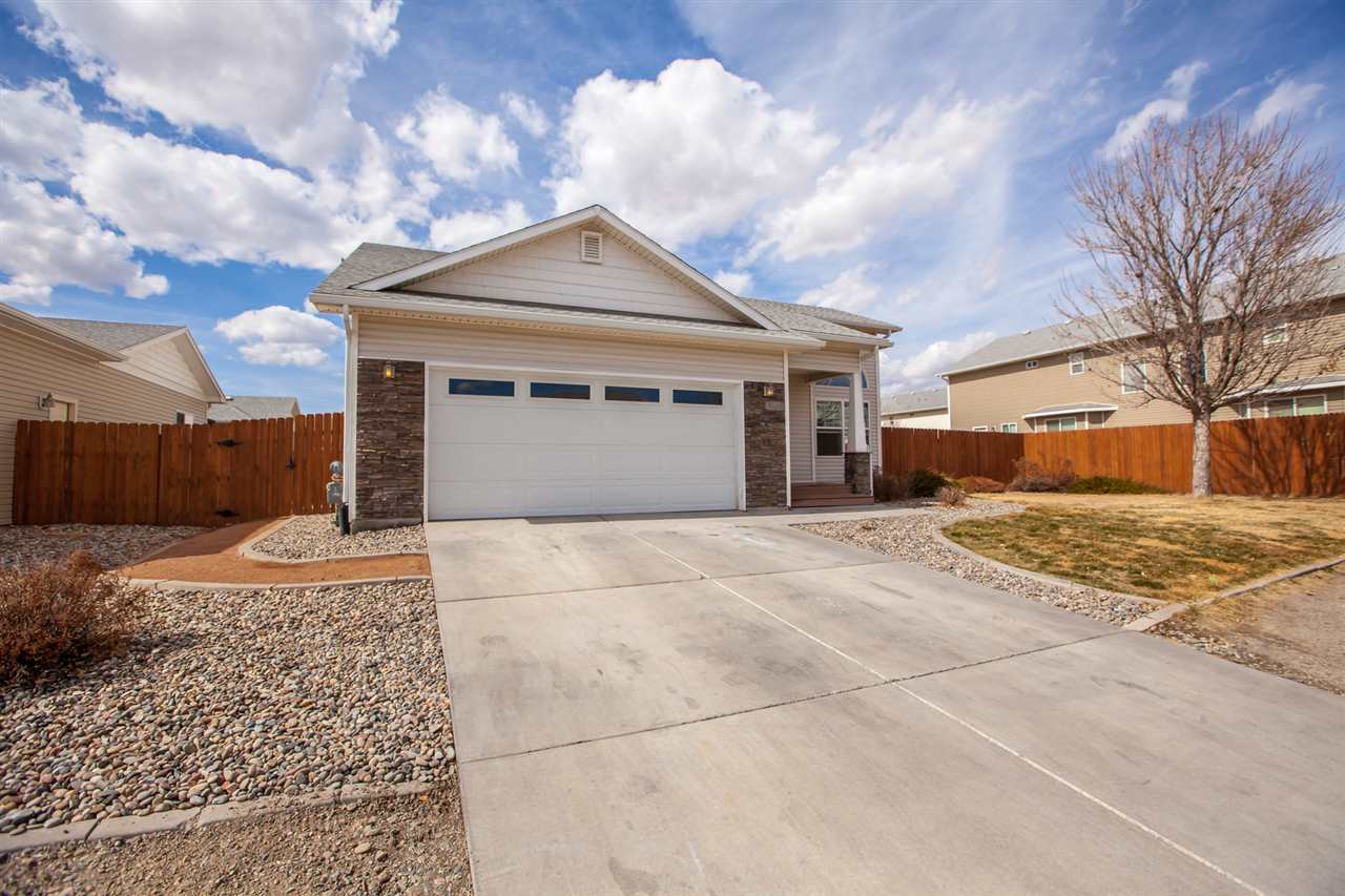 3138 Dublin Way Grand Junction, CO 81504 - Photo 42 of 42 a front view of a house with a yard and garage