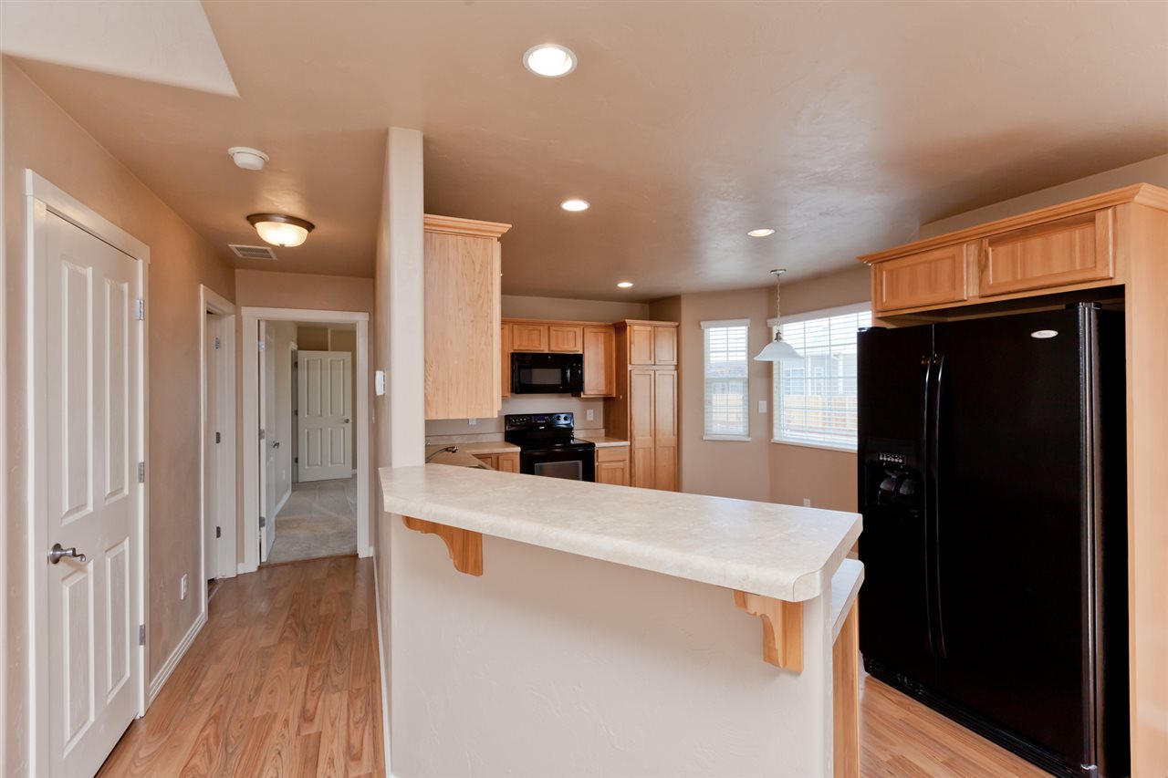 3138 Dublin Way Grand Junction, CO 81504 - Photo 7 of 42 a large kitchen with a large counter top stainless steel appliances and cabinets