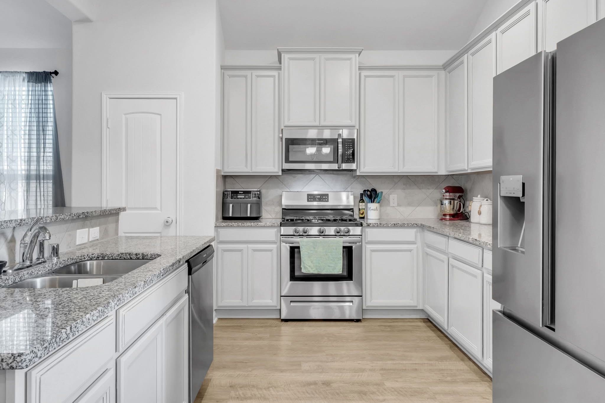 1495 Alice Drive Beaumont, TX 77705 - Photo 4 of 8 a kitchen with stainless steel appliances granite countertop a sink stove and refrigerator