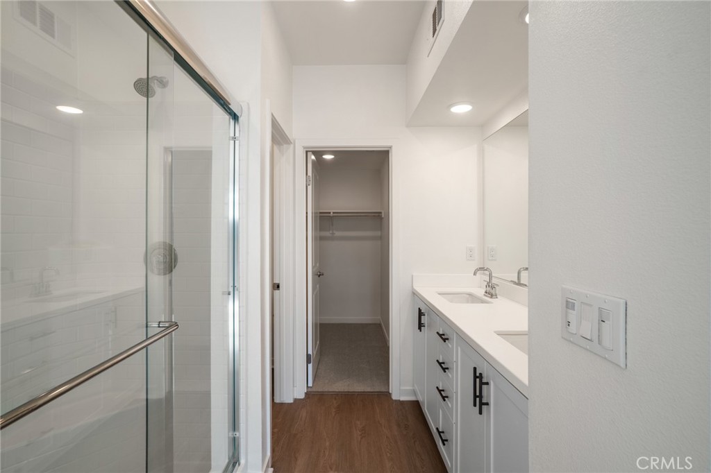 11055 Wander Drive Rancho Cucamonga, CA 91730 - Photo 12 of 28 a bathroom with a double vanity sink and a mirror