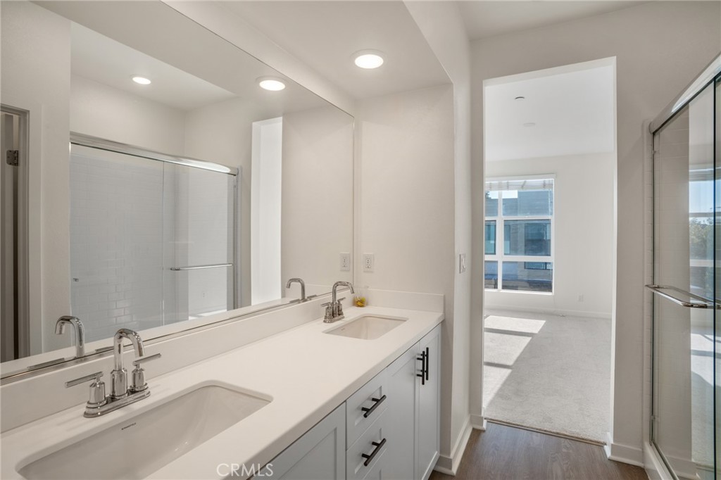 11055 Wander Drive Rancho Cucamonga, CA 91730 - Photo 13 of 28 a bathroom with a sink double vanity and a mirror