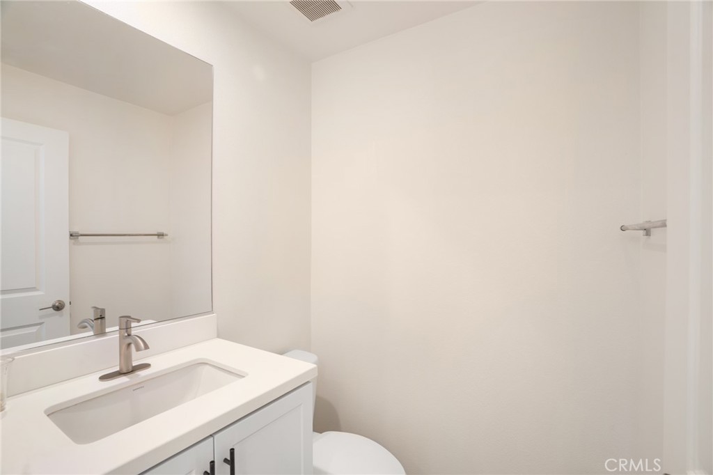 11055 Wander Drive Rancho Cucamonga, CA 91730 - Photo 16 of 28 a bathroom with a sink a toilet and mirror