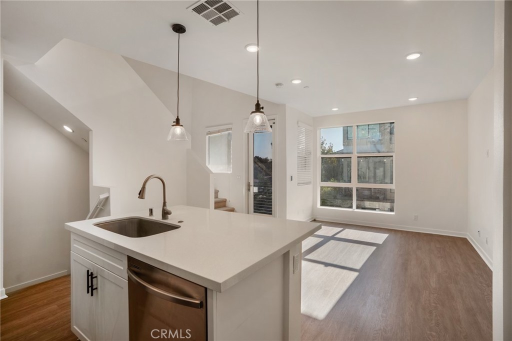 11055 Wander Drive Rancho Cucamonga, CA 91730 - Photo 8 of 28 a kitchen with a sink a faucet a potted plant and a large window