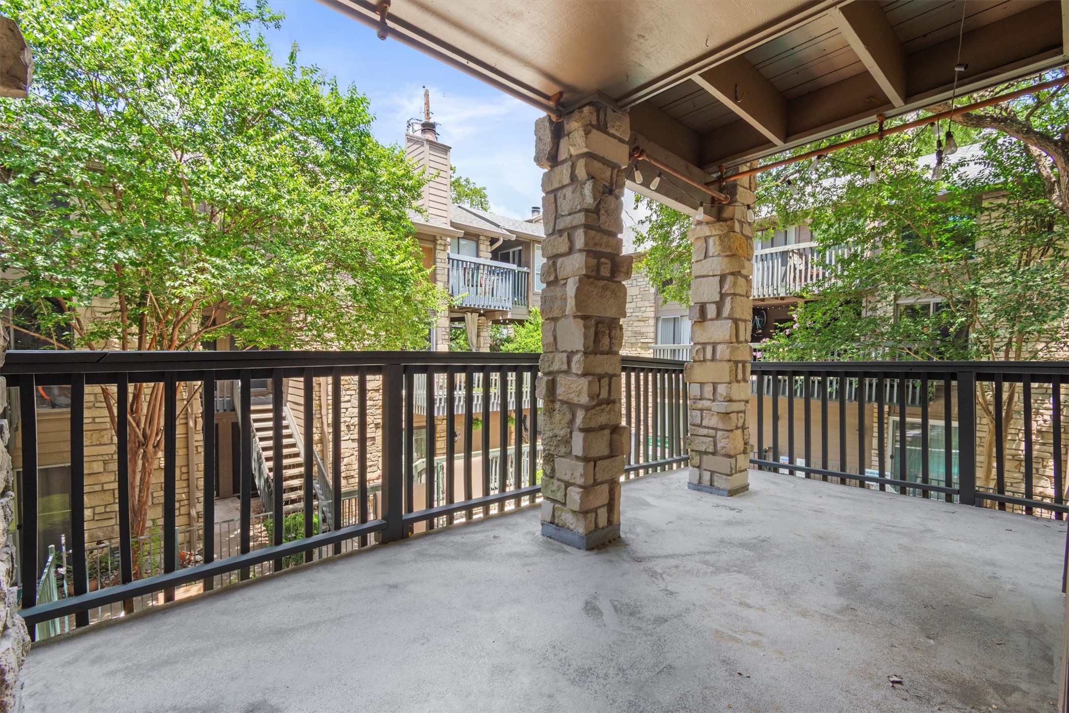 3627 Menchaca Road, Unit 204 Austin, TX 78704 - Photo 9 of 23 Enjoy outdoor moments on this covered balcony, perfect for relaxation and enjoying the community surroundings.