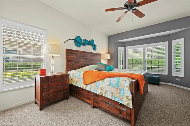 a bed sitting in a room next to a window