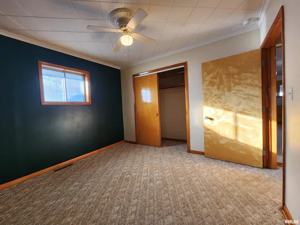 an empty room with windows and closet