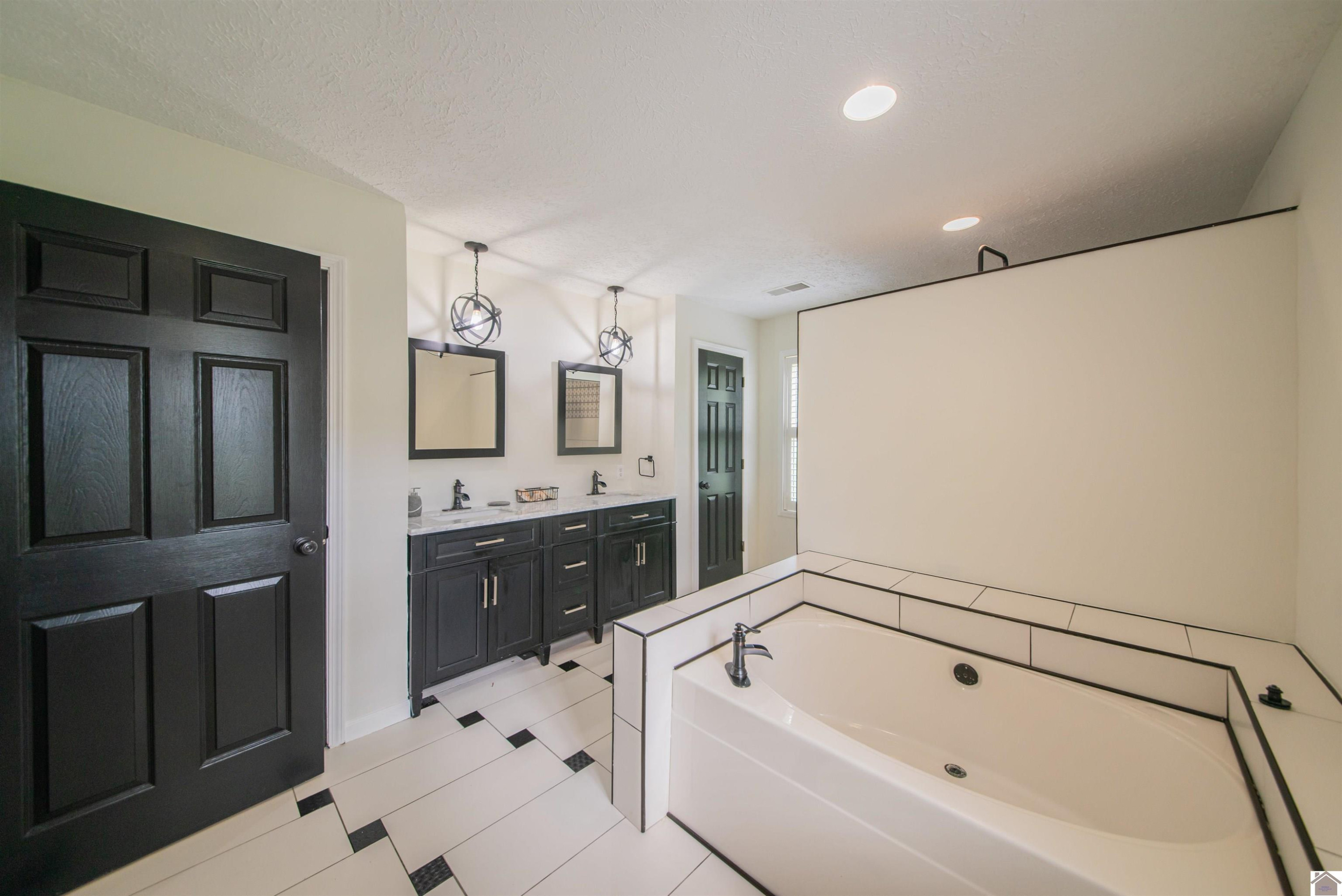 2520 Moss Road Kevil, KY 42053 - Photo 23 of 50 Dual sink vanity, soaking tub, walk in custom tile shower Primary bath