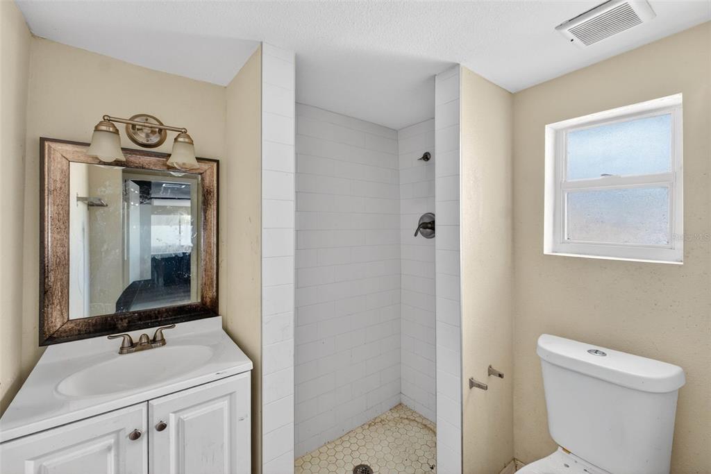 842 Channing Road Lakeland, FL 33805 - Photo 13 of 27 a bathroom with a sink a toilet and mirror