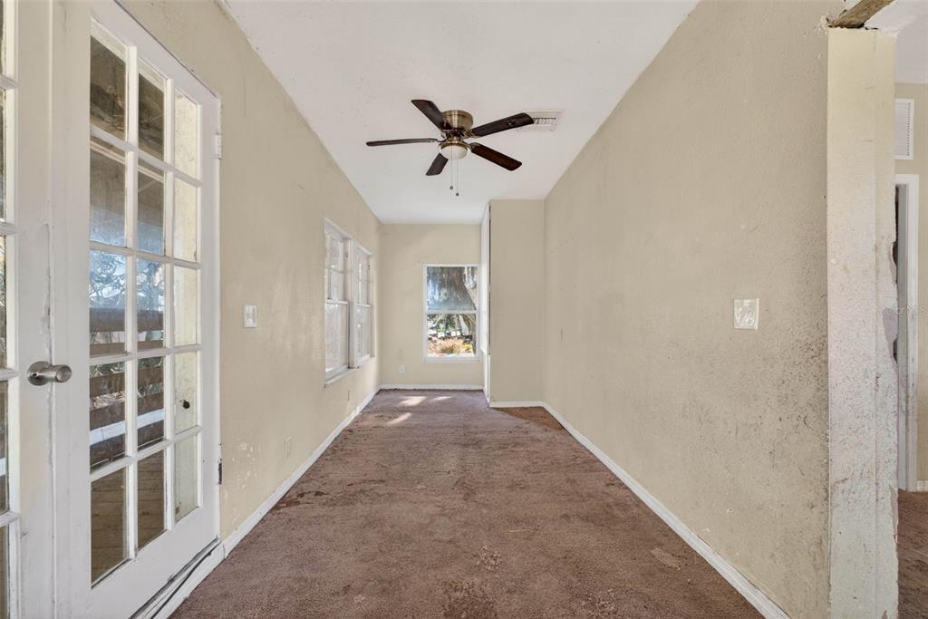 842 Channing Road Lakeland, FL 33805 - Photo 15 of 27 a view of a hallway with windows and chandelier fan
