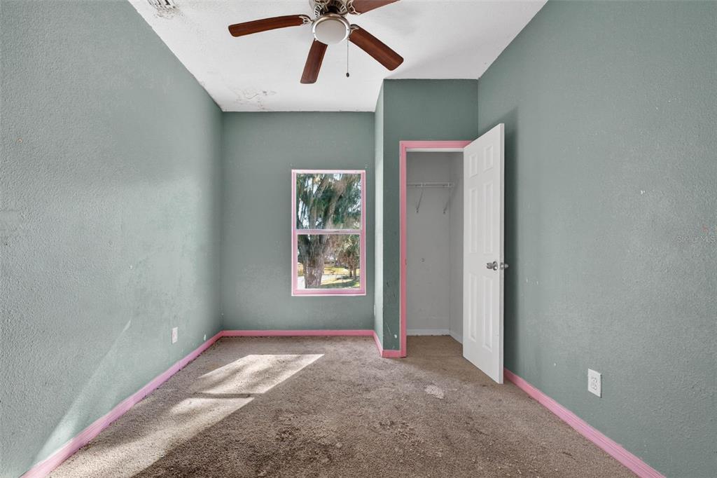 842 Channing Road Lakeland, FL 33805 - Photo 17 of 27 an empty room with windows and fan