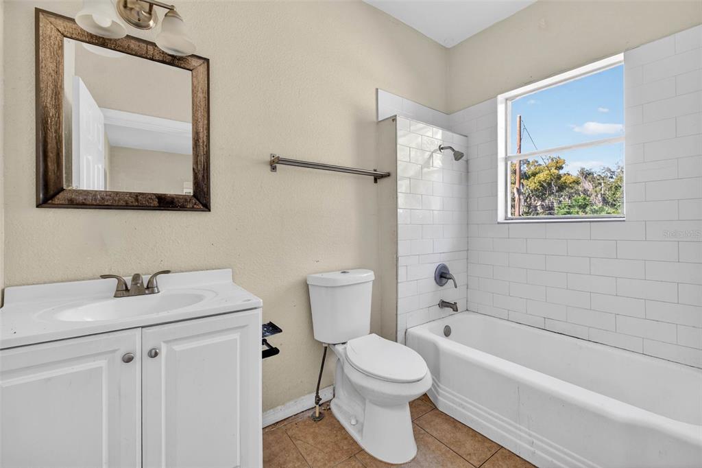 842 Channing Road Lakeland, FL 33805 - Photo 21 of 27 a bathroom with a sink a toilet and bathtub