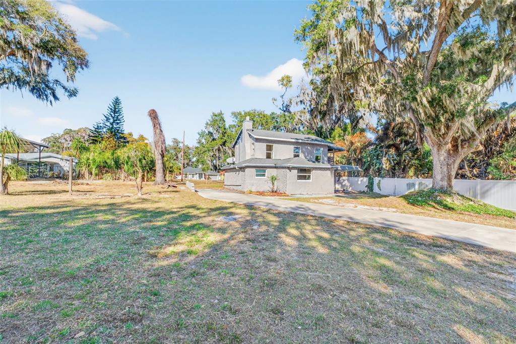 842 Channing Road Lakeland, FL 33805 - Photo 24 of 27 a view of a house with backyard and a tree