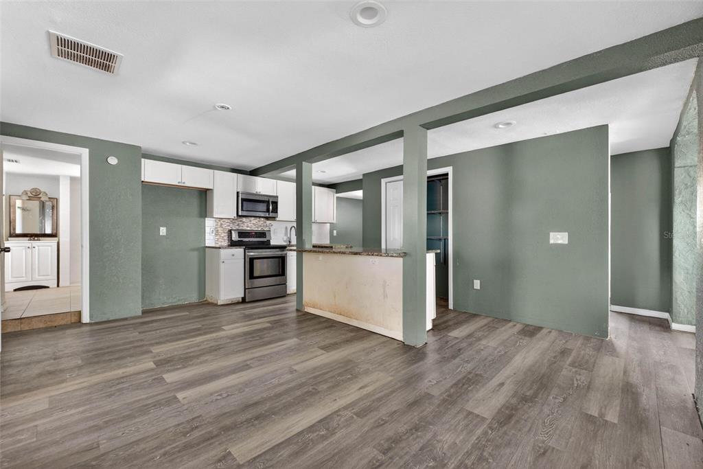 842 Channing Road Lakeland, FL 33805 - Photo 5 of 27 a view of a kitchen with a refrigerator and a stove