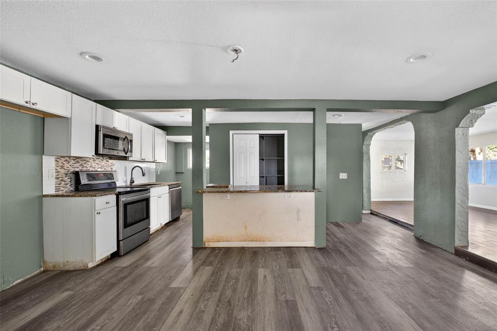 842 Channing Road Lakeland, FL 33805 - Photo 6 of 27 a large kitchen with cabinets wooden floor and stainless steel appliances