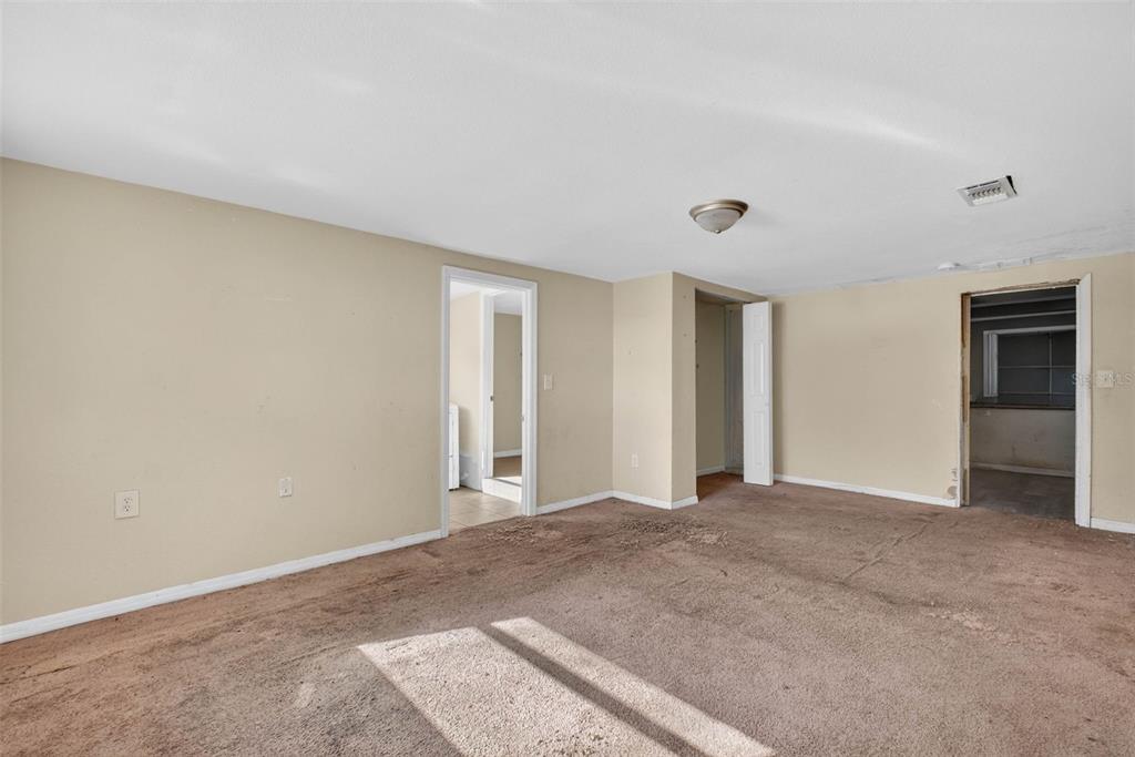 842 Channing Road Lakeland, FL 33805 - Photo 9 of 27 a view of an empty room with window and closet area