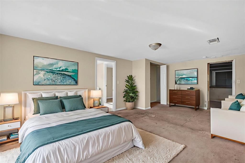 842 Channing Road Lakeland, FL 33805 - Photo 10 of 27 a bedroom with a large bed and a couch