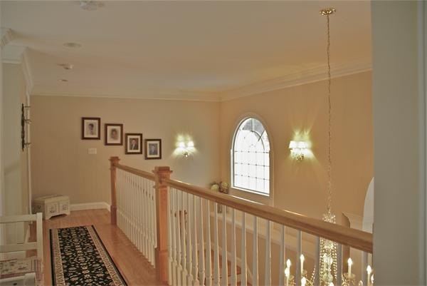 11 Amanda Road Sudbury, MA 01776 - Photo 26 of 30 a view of a hallway to a livingroom with wooden floor and stairs