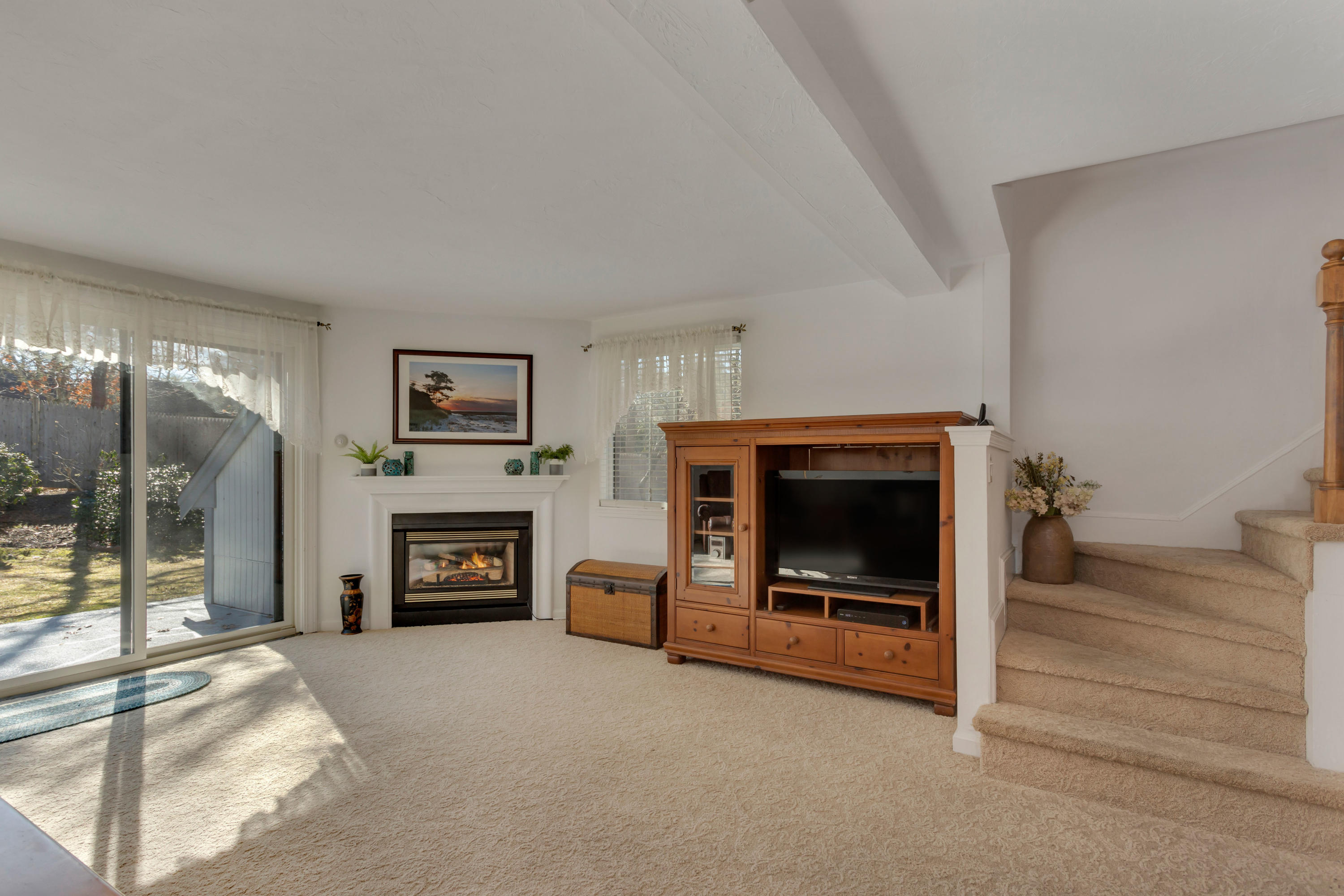 22 Crescent Lane Brewster, MA 02631 - Photo 15 of 43 a living room with furniture and a fireplace
