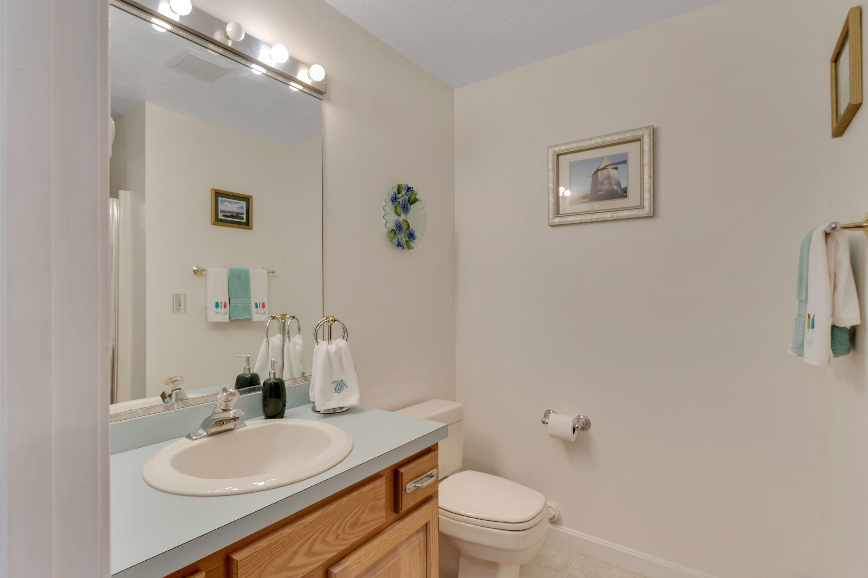 22 Crescent Lane Brewster, MA 02631 - Photo 23 of 43 a bathroom with a toilet sink and mirror