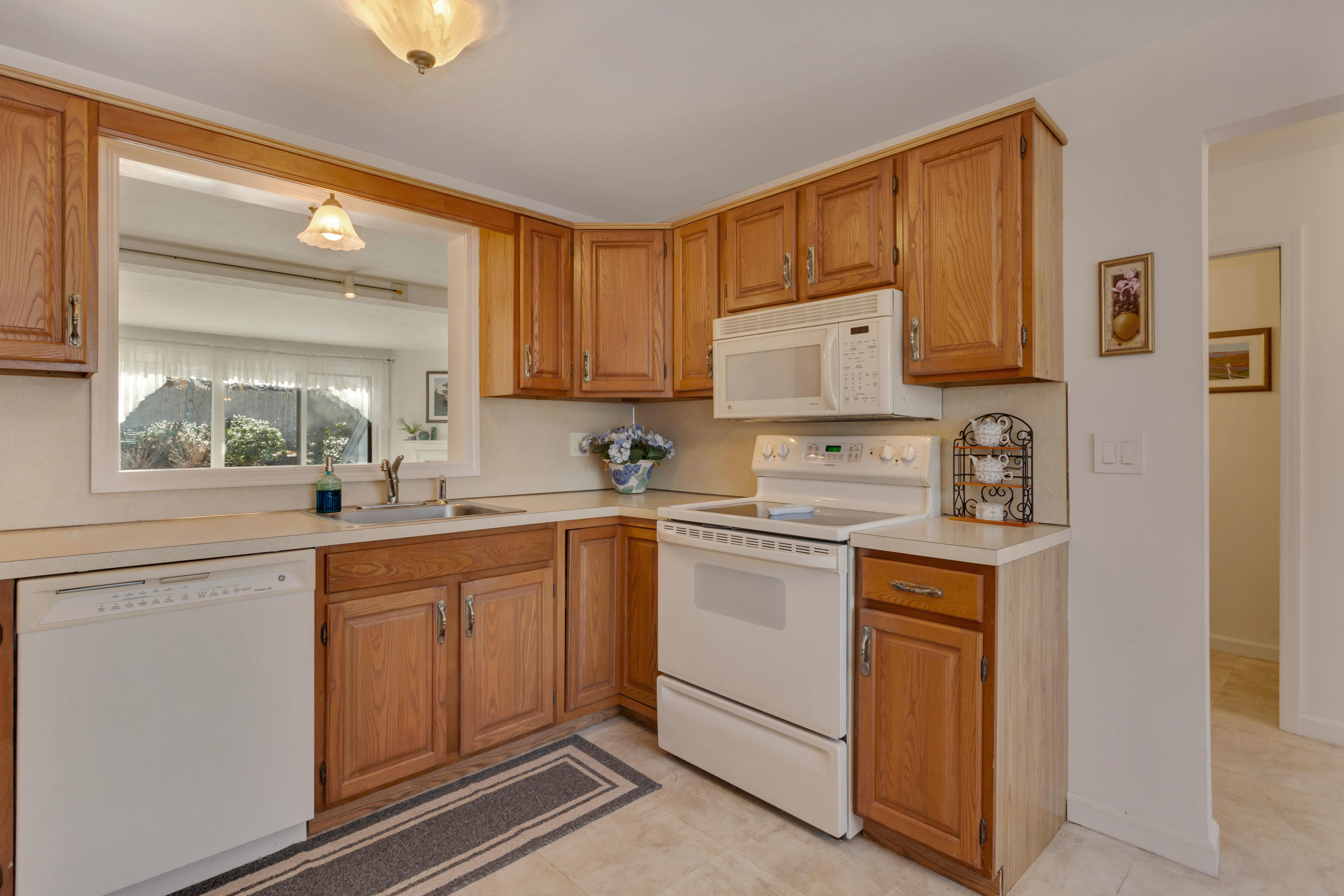 22 Crescent Lane Brewster, MA 02631 - Photo 9 of 43 a kitchen with stainless steel appliances granite countertop a sink and cabinets