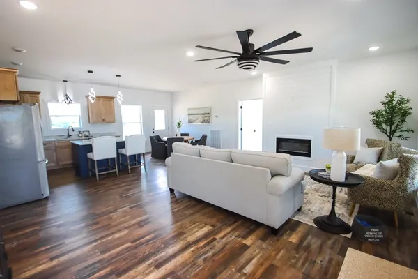 a living room with furniture and a wooden floor