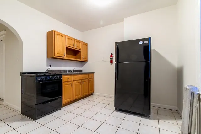 a kitchen with a refrigerator and a stove