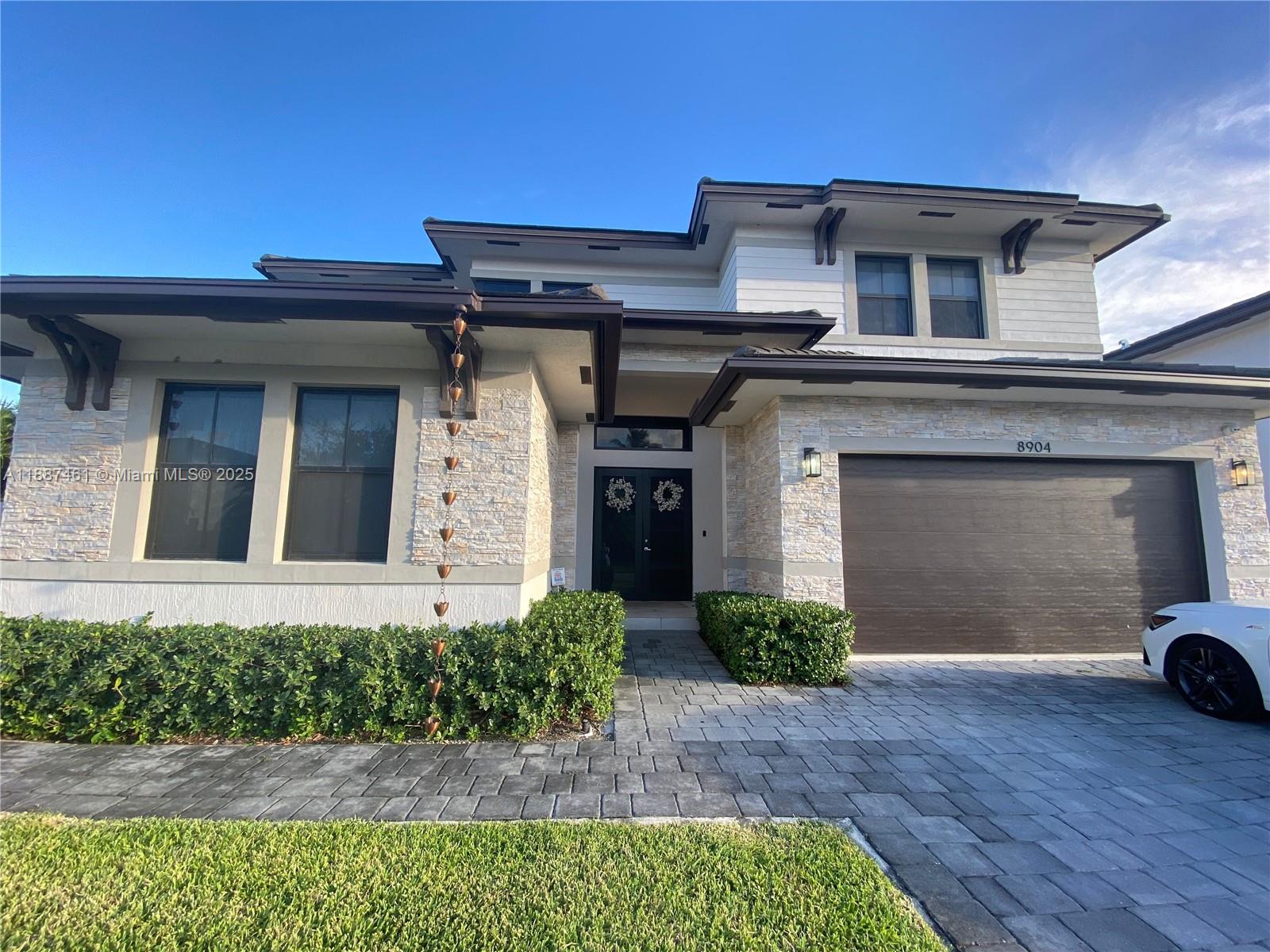 a front view of a house with garden