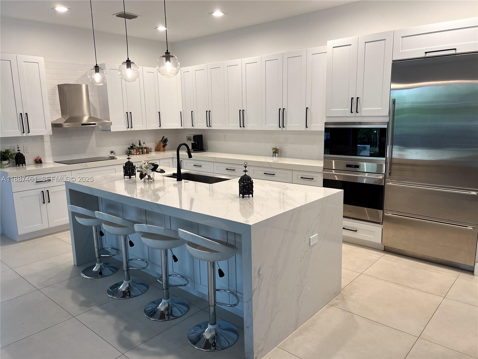 8904 Southwest 69th Trail Miami, FL 33173 - Photo 15 of 42 a kitchen with a sink stainless steel appliances and cabinets