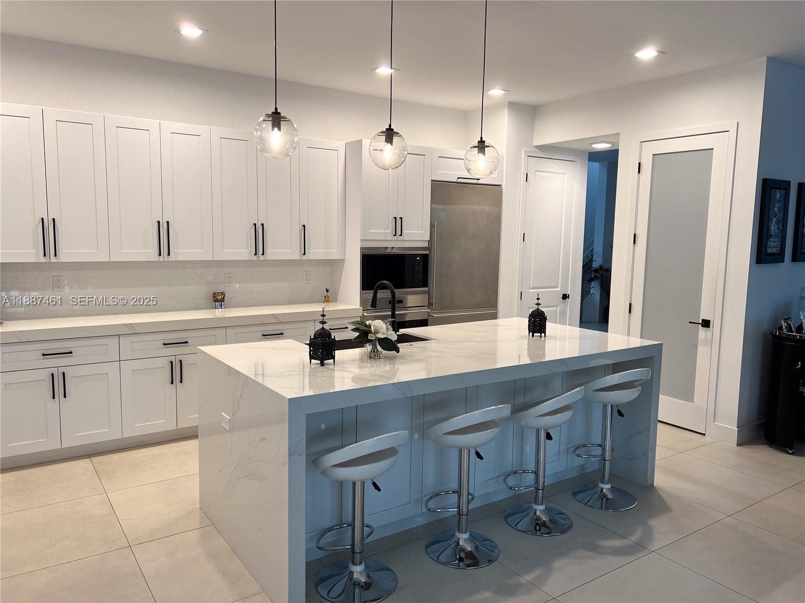 8904 Southwest 69th Trail Miami, FL 33173 - Photo 17 of 42 a kitchen with a sink a counter space appliances and cabinets