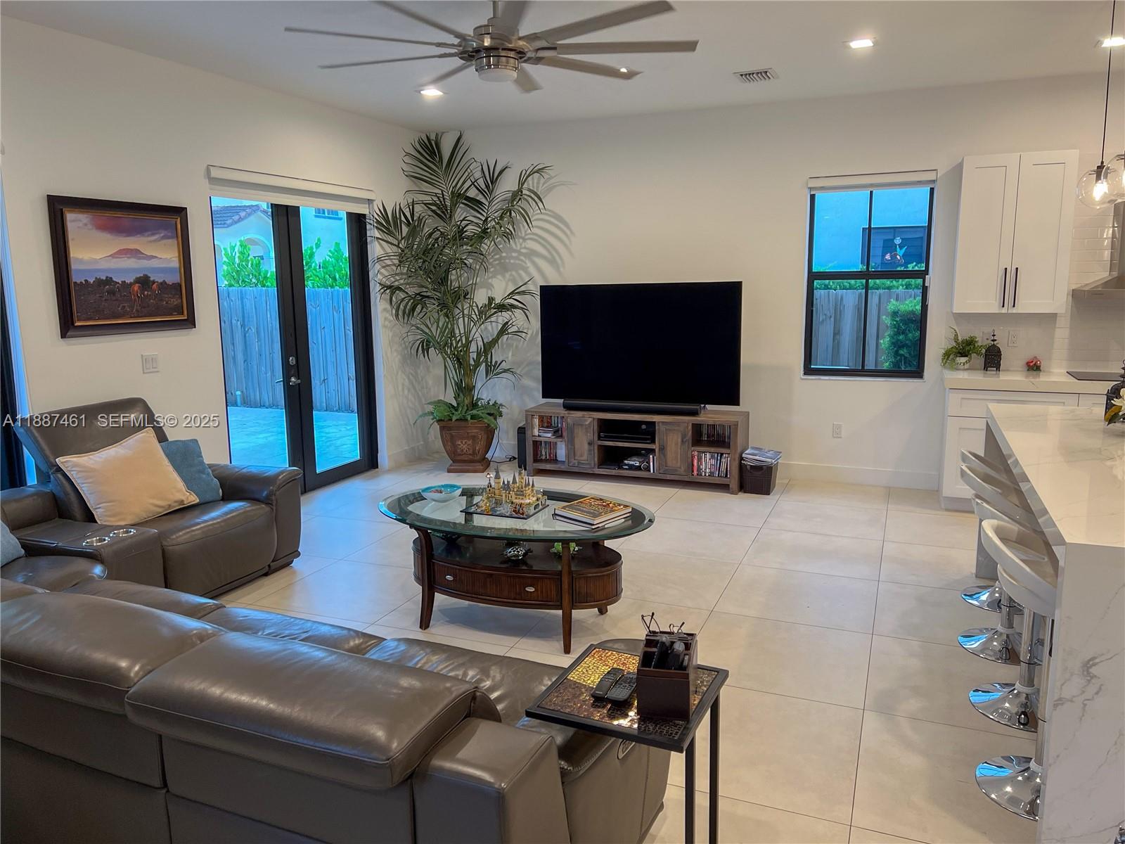 8904 Southwest 69th Trail Miami, FL 33173 - Photo 19 of 42 a living room with furniture and a flat screen tv