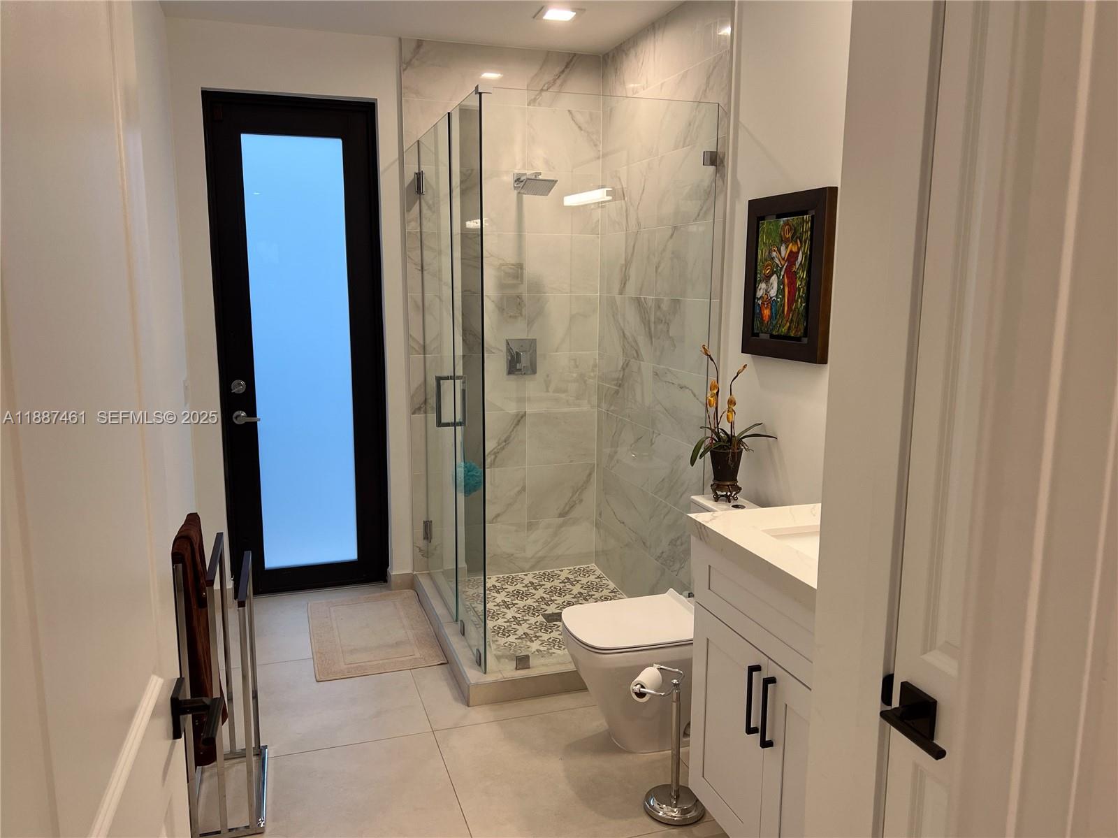 8904 Southwest 69th Trail Miami, FL 33173 - Photo 21 of 42 a bathroom with a shower a sink and a toilet