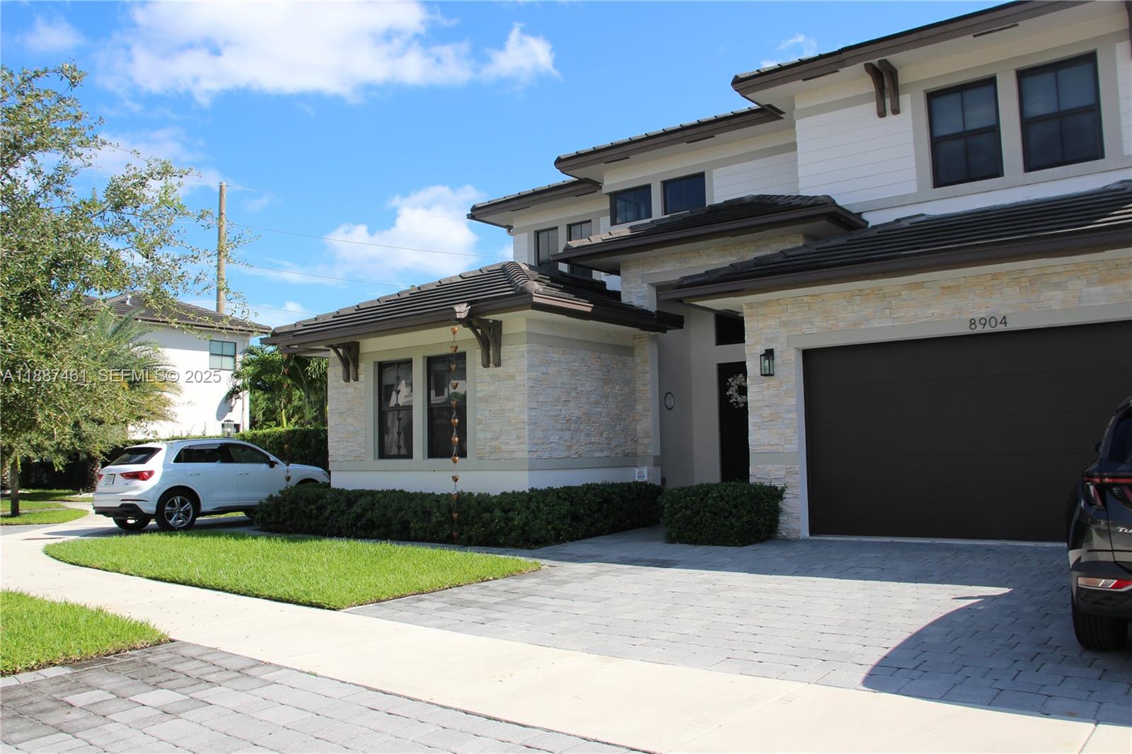 8904 Southwest 69th Trail Miami, FL 33173 - Photo 3 of 42 a front view of a house with a yard