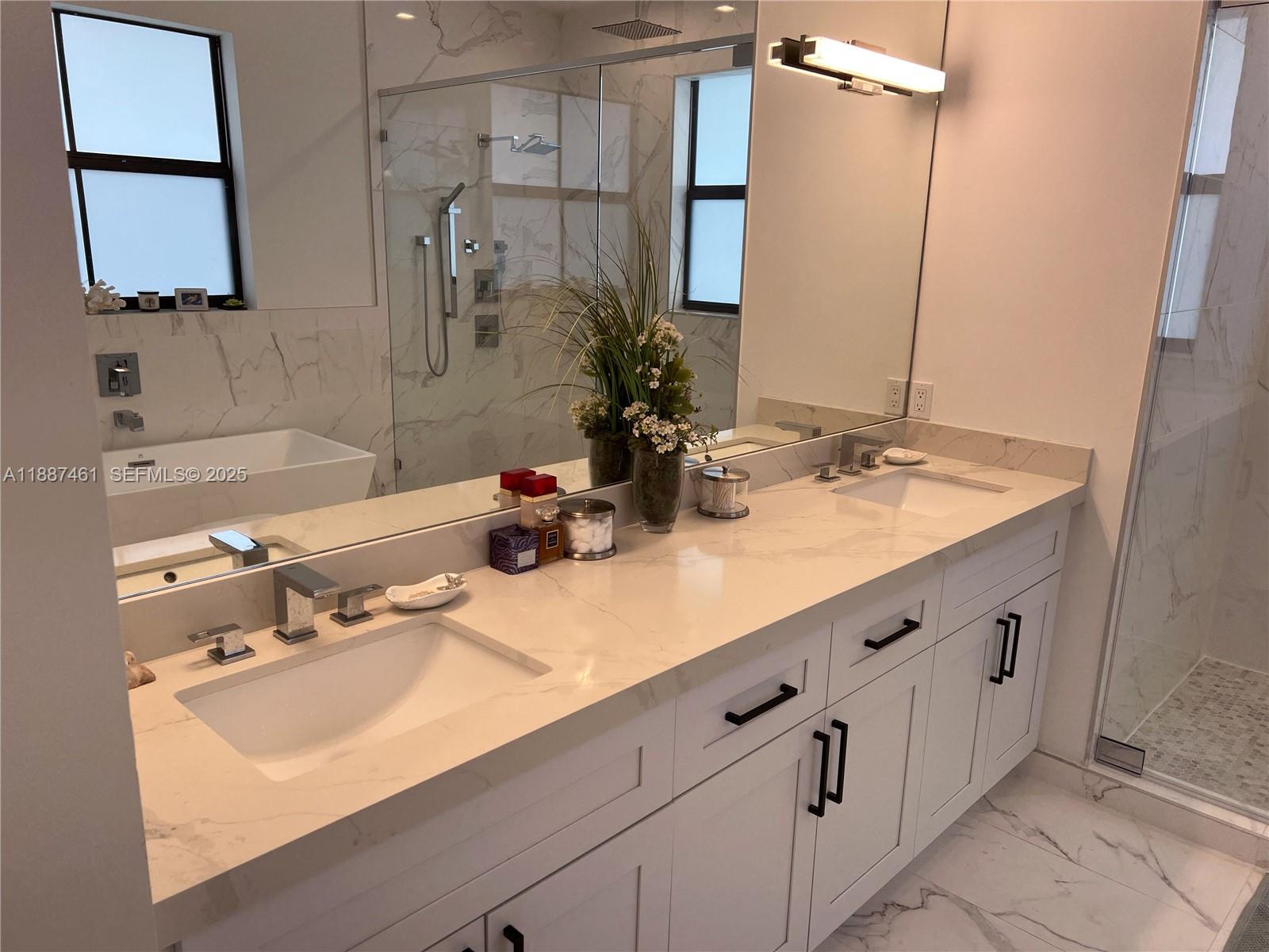 8904 Southwest 69th Trail Miami, FL 33173 - Photo 31 of 42 a bathroom with a sink and a mirror