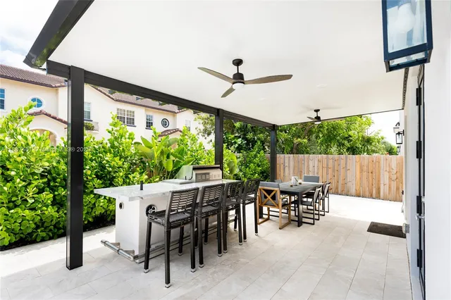 a dining room with furniture and a floor to ceiling window