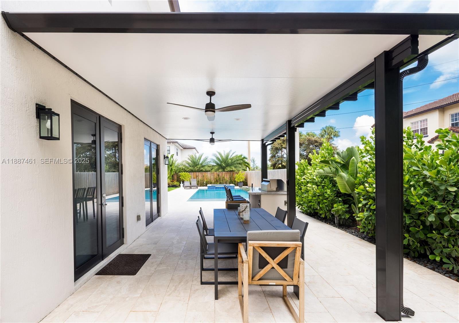 8904 Southwest 69th Trail Miami, FL 33173 - Photo 35 of 42 a dining room with furniture and a floor to ceiling window