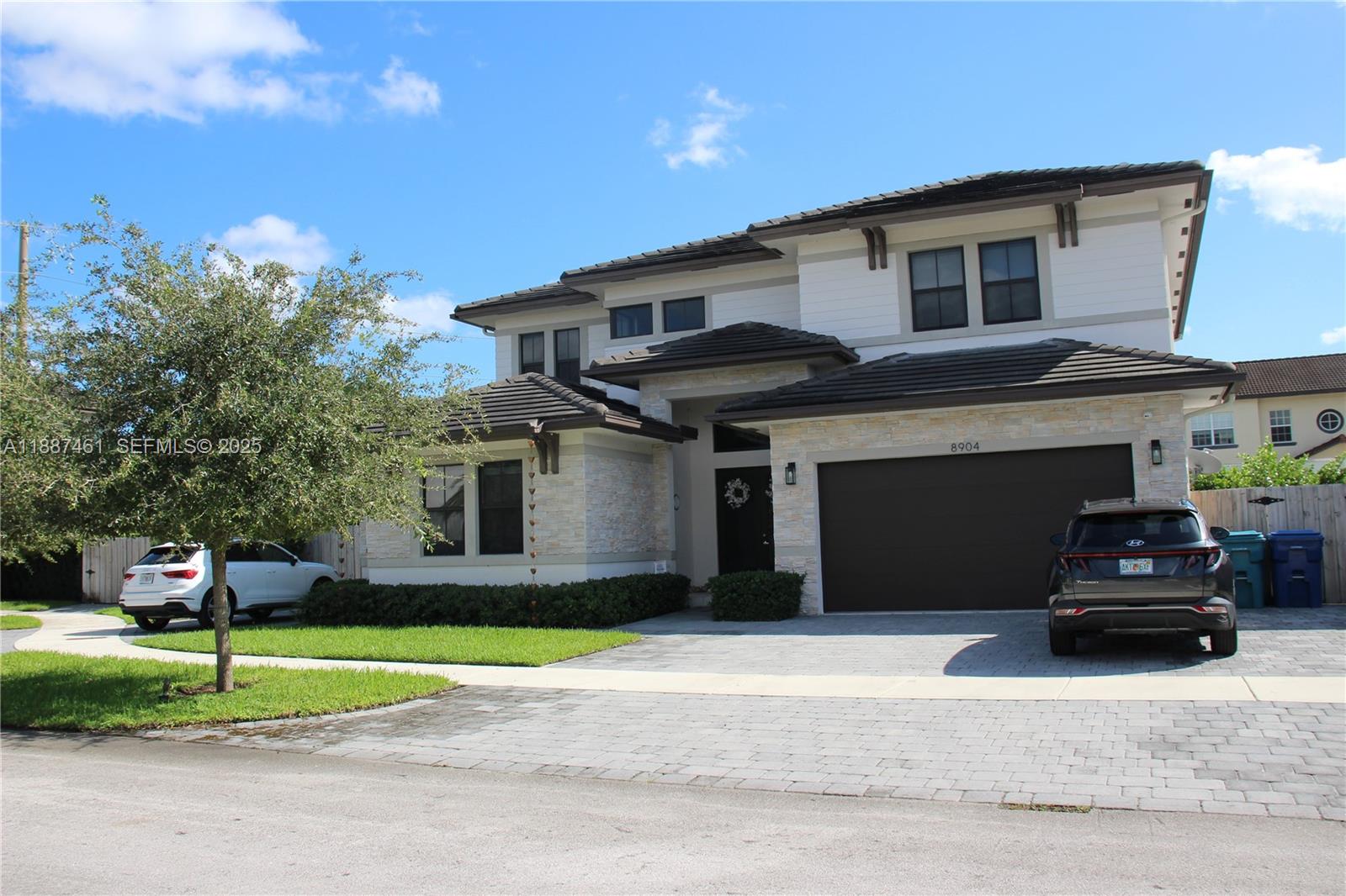 8904 Southwest 69th Trail Miami, FL 33173 - Photo 4 of 42 a front view of a house with a yard
