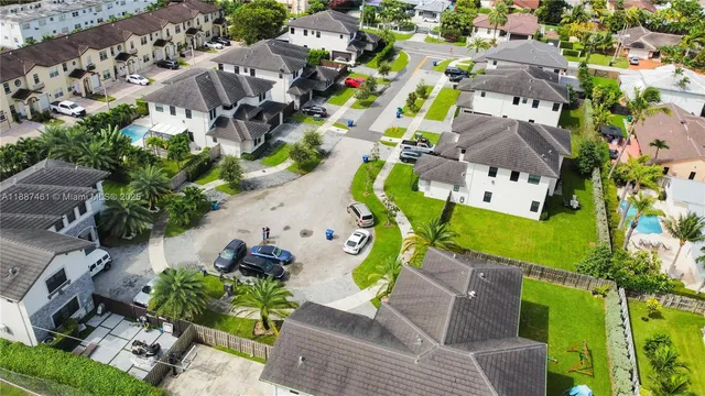 an aerial view of multiple houses with yard