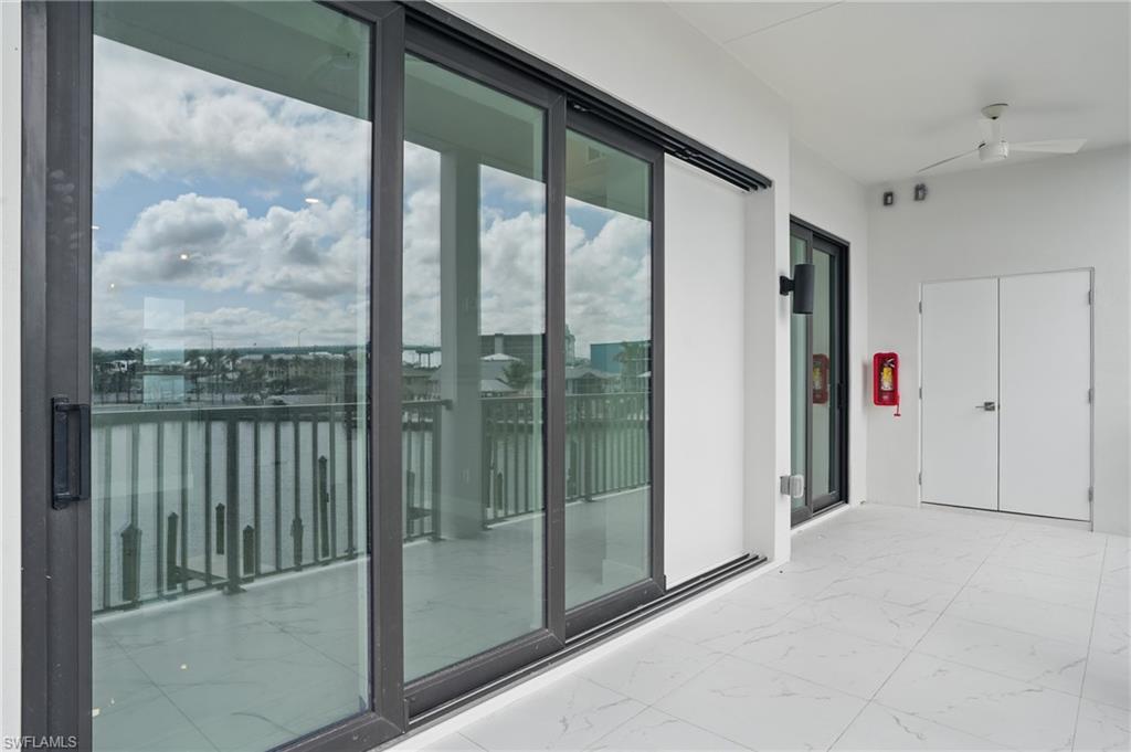 855 Lagoon Street, Unit 4 Fort Myers Beach, FL 33931 - Photo 17 of 40 a view of a glass door and the balcony