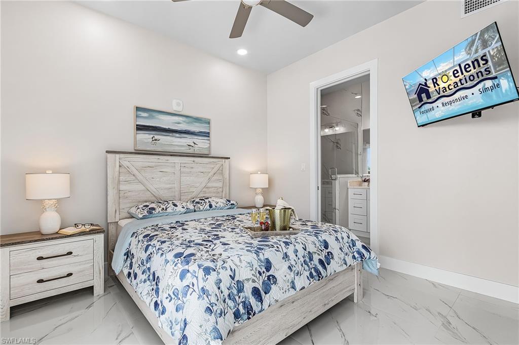855 Lagoon Street, Unit 4 Fort Myers Beach, FL 33931 - Photo 20 of 40 a bedroom with a bed and a lamp