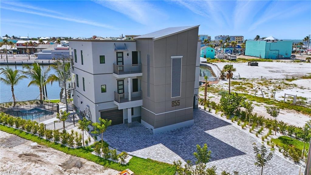 855 Lagoon Street, Unit 4 Fort Myers Beach, FL 33931 - Photo 2 of 40 a view of a house with a yard