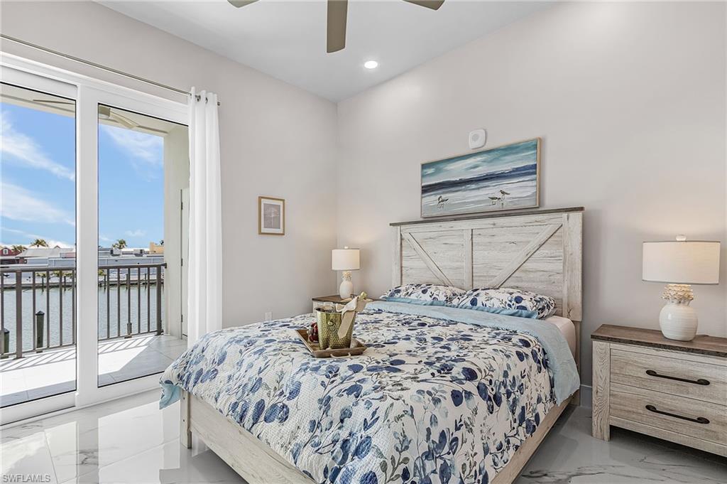 855 Lagoon Street, Unit 4 Fort Myers Beach, FL 33931 - Photo 22 of 40 a bedroom with a bed and a night stand