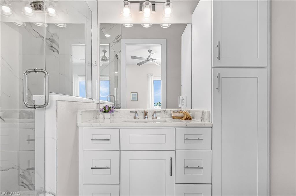 855 Lagoon Street, Unit 4 Fort Myers Beach, FL 33931 - Photo 24 of 40 a bathroom with a double vanity sink mirror and double