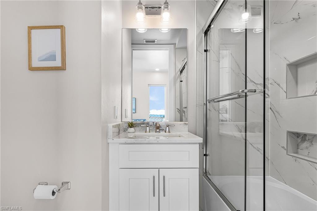 855 Lagoon Street, Unit 4 Fort Myers Beach, FL 33931 - Photo 28 of 40 a bathroom with a sink and a mirror