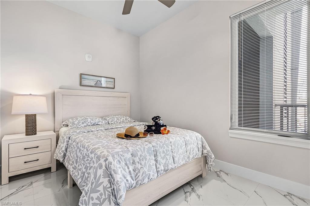 855 Lagoon Street, Unit 4 Fort Myers Beach, FL 33931 - Photo 30 of 40 a bedroom with a bed and window