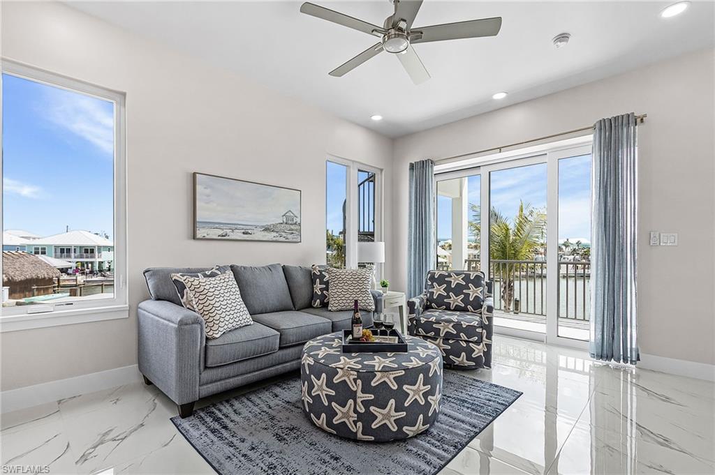 855 Lagoon Street, Unit 4 Fort Myers Beach, FL 33931 - Photo 35 of 40 a living room with furniture and a large window
