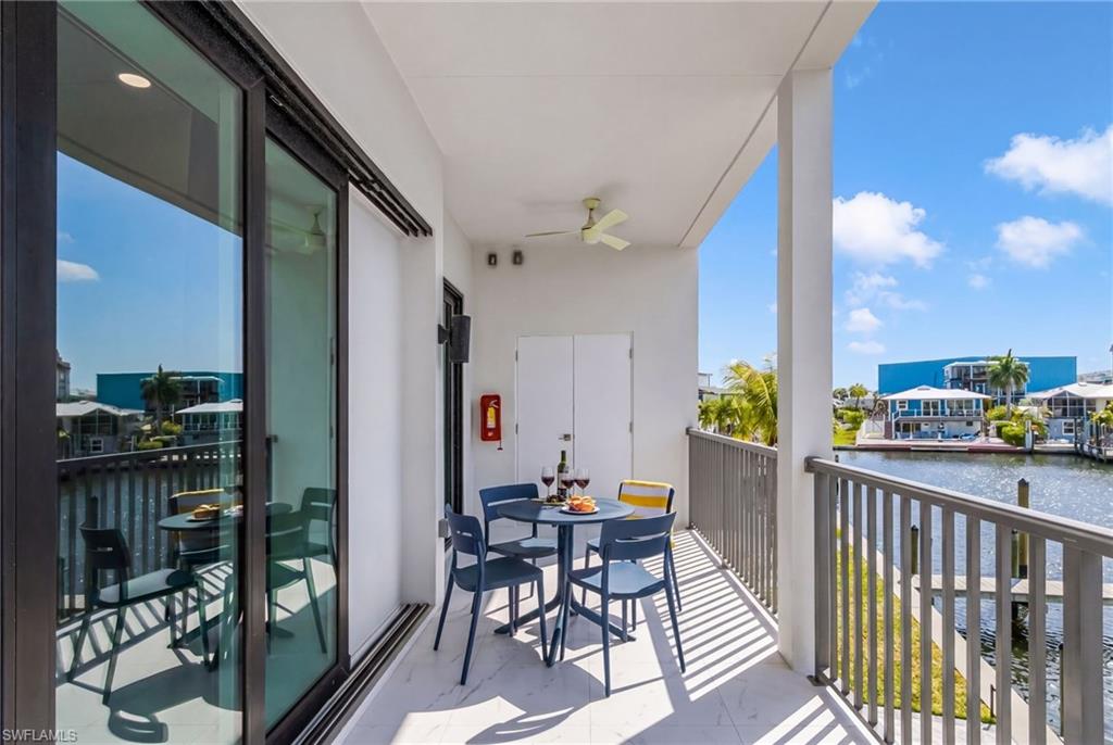 855 Lagoon Street, Unit 4 Fort Myers Beach, FL 33931 - Photo 39 of 40 a view of a balcony dining table and chairs