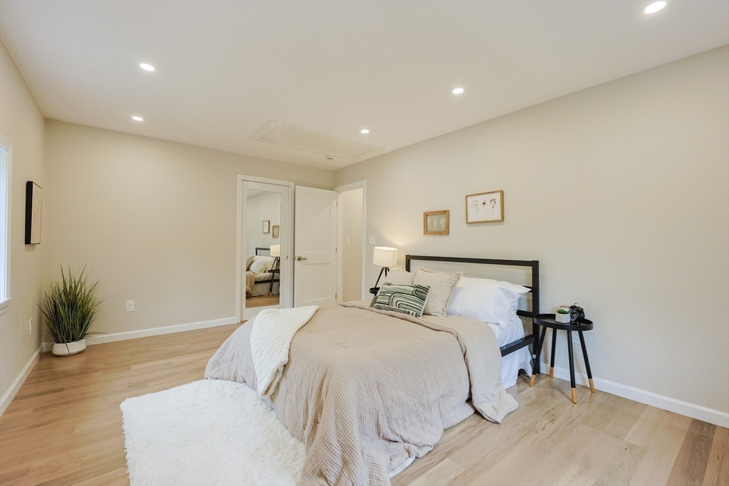 81 Elliott Street Danvers, MA 01923 - Photo 12 of 31 a bed room with a bed and a potted plant