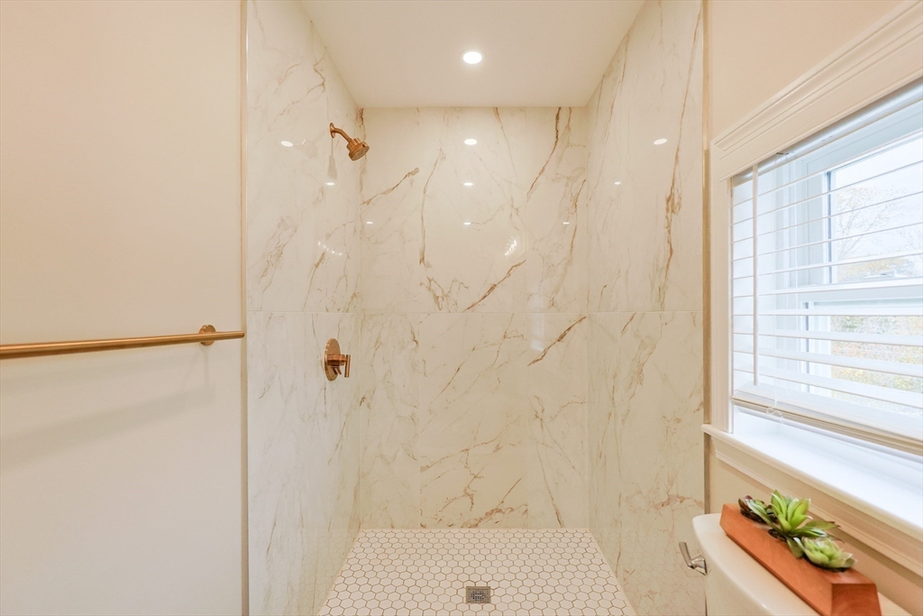 81 Elliott Street Danvers, MA 01923 - Photo 18 of 31 a bathroom with a bathtub and a shower